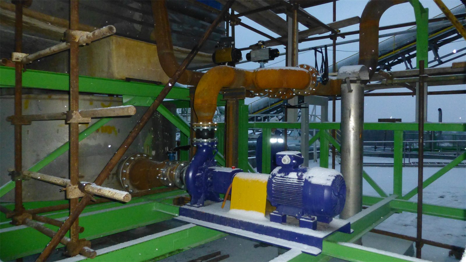 New pump on a green steel platform of the gas treatment unit during commissioning in winter