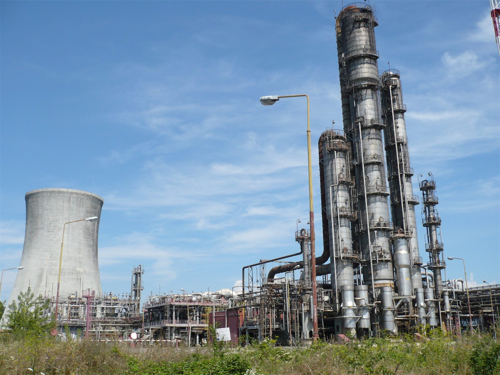 Distillation columns of the cyclohexanone plant at Strážske with a cooling tower behind, before dismantling