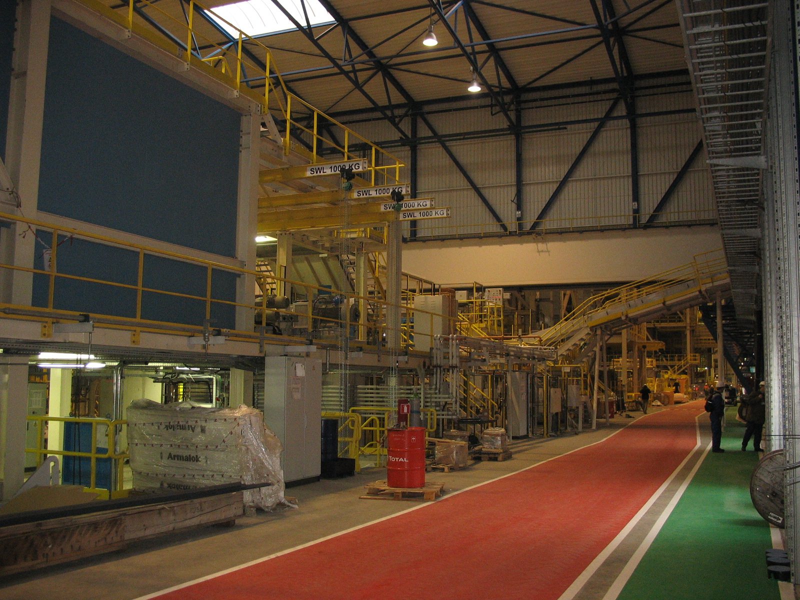 Hall of the galvanising line as built, with a red walkway, platforms and equipment
