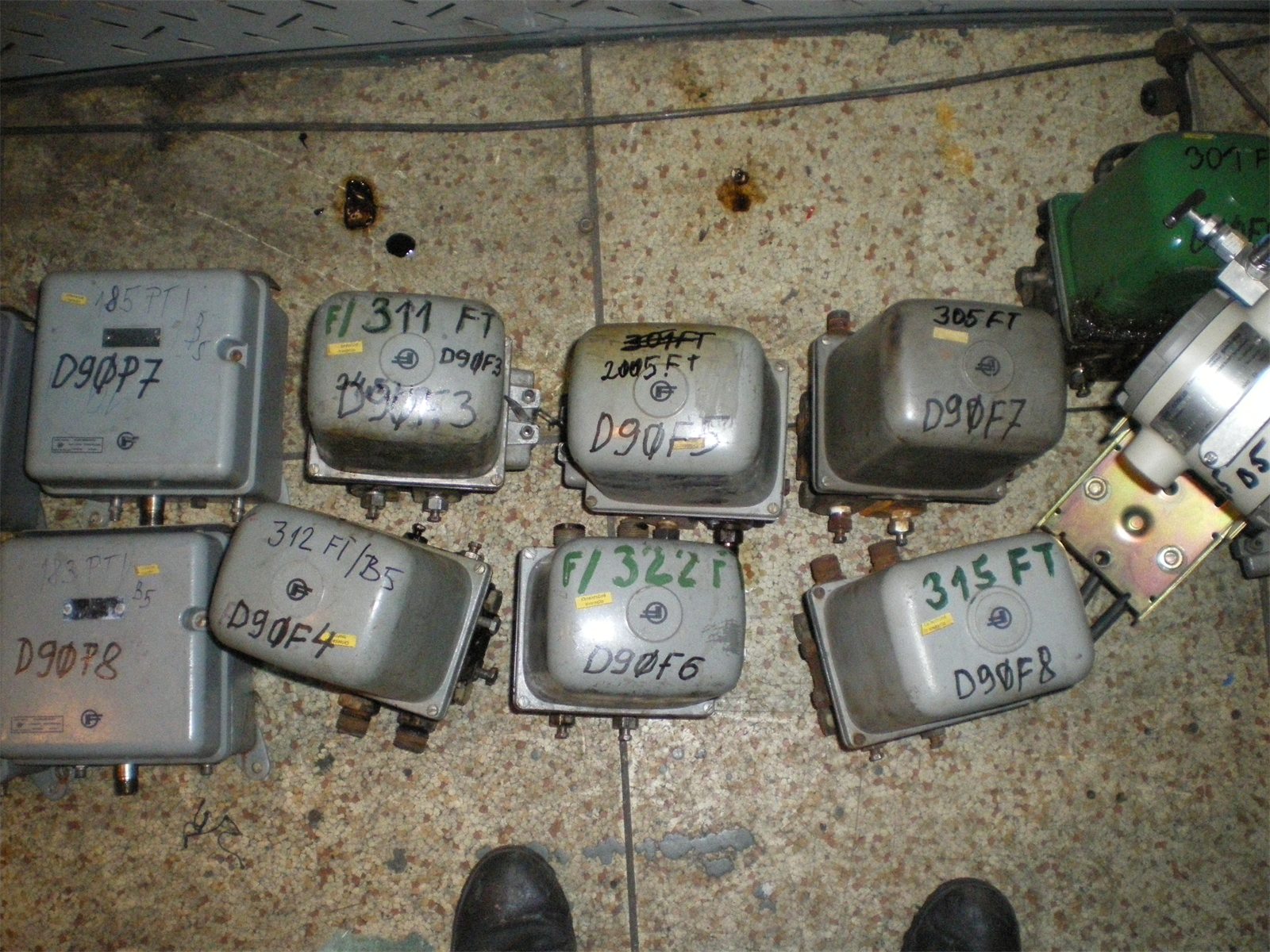 Removed transmitters laid out on the floor, each marked with its tag for re-erection